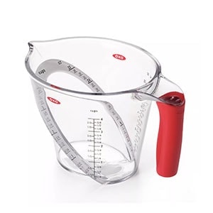 a measuring cup with a red handle.