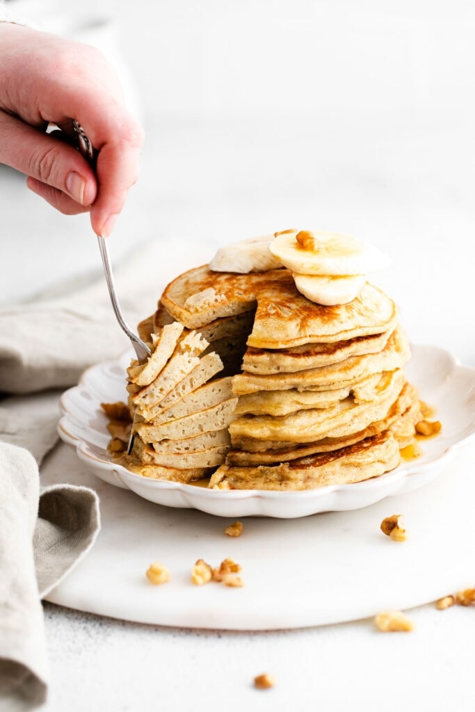 forking stack of pancakes.