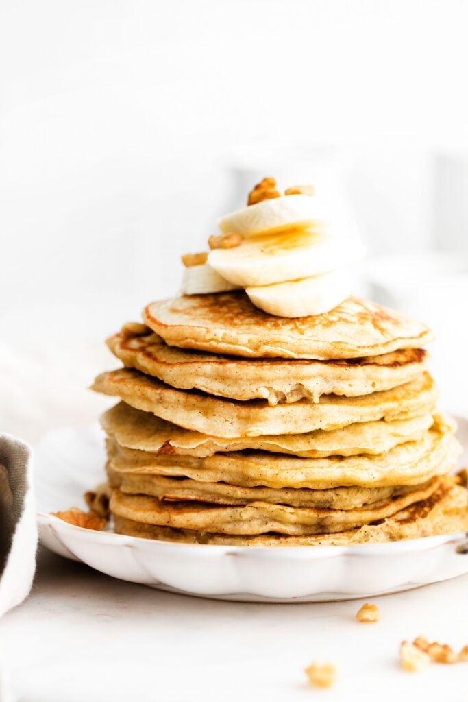 stack of pancakes with banana on top.