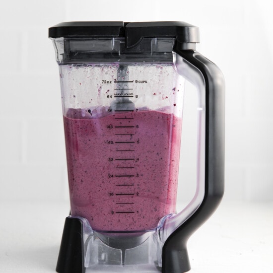 a blender filled with blueberry smoothie.