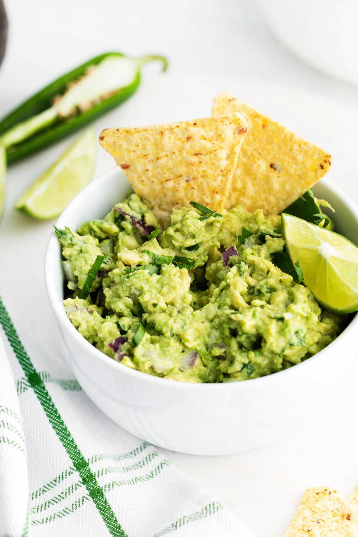 Guacamole with tortilla chips in the guacamole. 