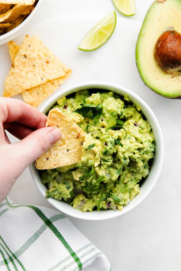 A tortilla chip scooping up guacamole