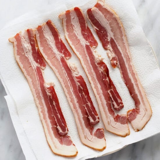 raw bacon on a plate.