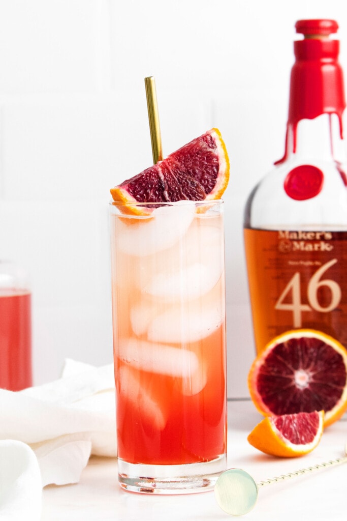 blood orange cocktail next to bourbon