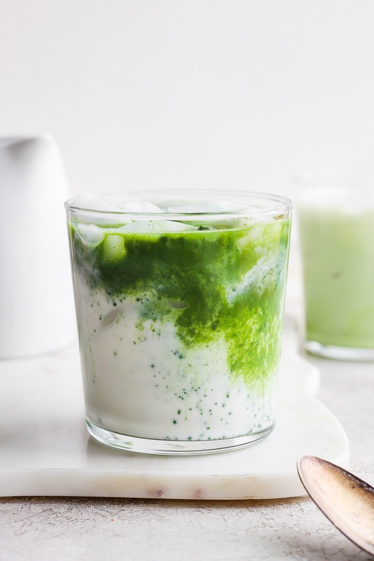 Iced latte with a matcha swirl in almond milk. 