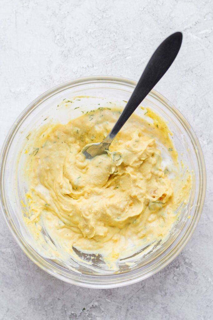 easy deviled eggs filling mixed together with a spoon in a bowl