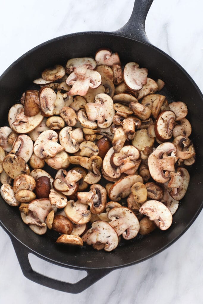 mushrooms ready to be sauteed in a cast iron skillet