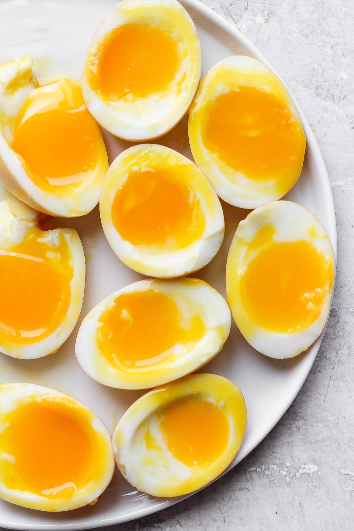 Soft boiled ramen eggs on a plate. 