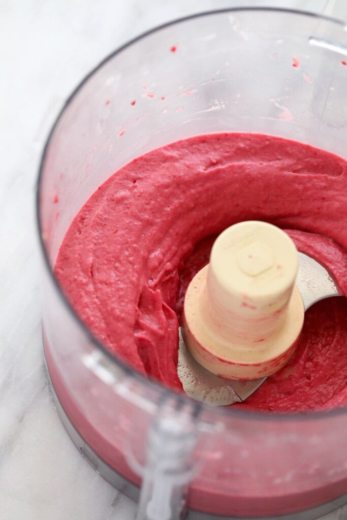 raspberry banana nice cream in a food processor blended to perfection