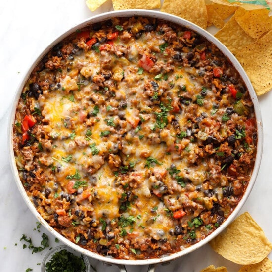 mexican bean dip in a skillet with tortilla chips.