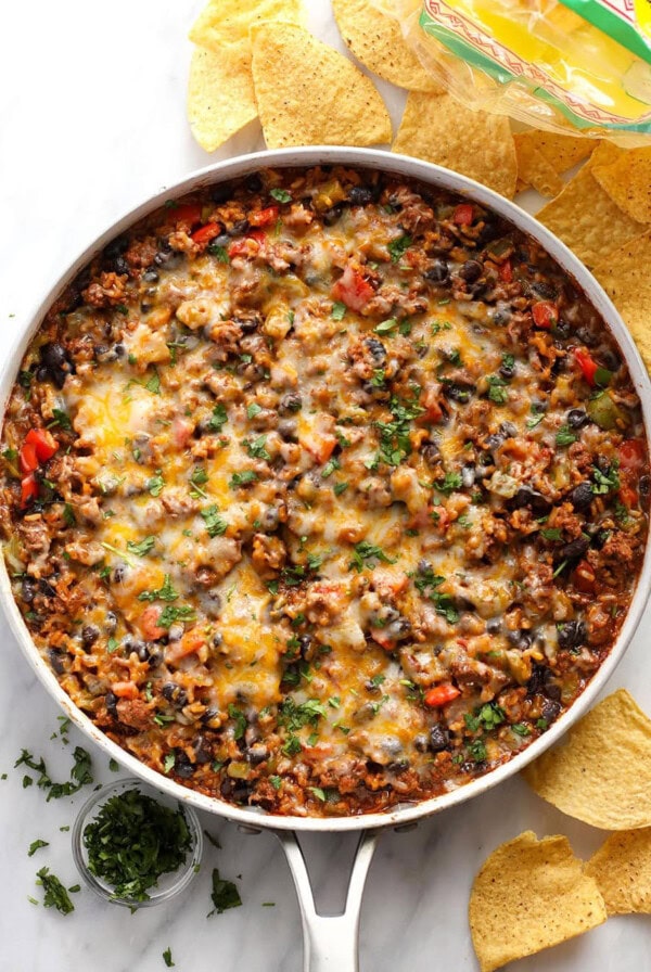 mexican bean dip in a skillet with tortilla chips.