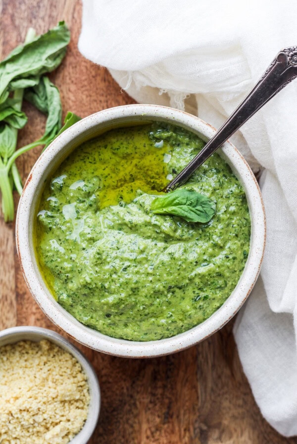 basil pesto in a bowl with a spoon.
