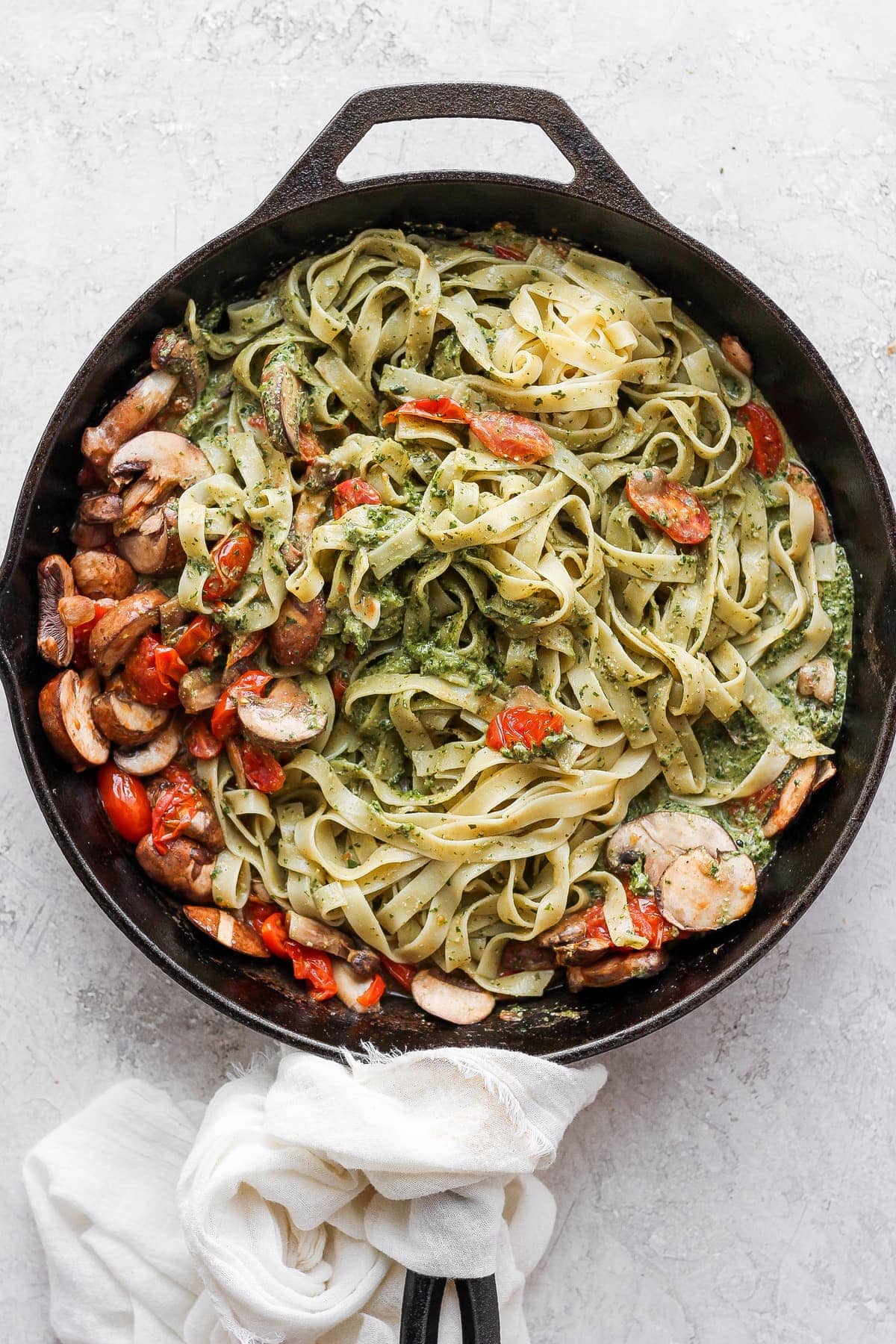 Vegan pesto pasta in a cast iron skillet. 