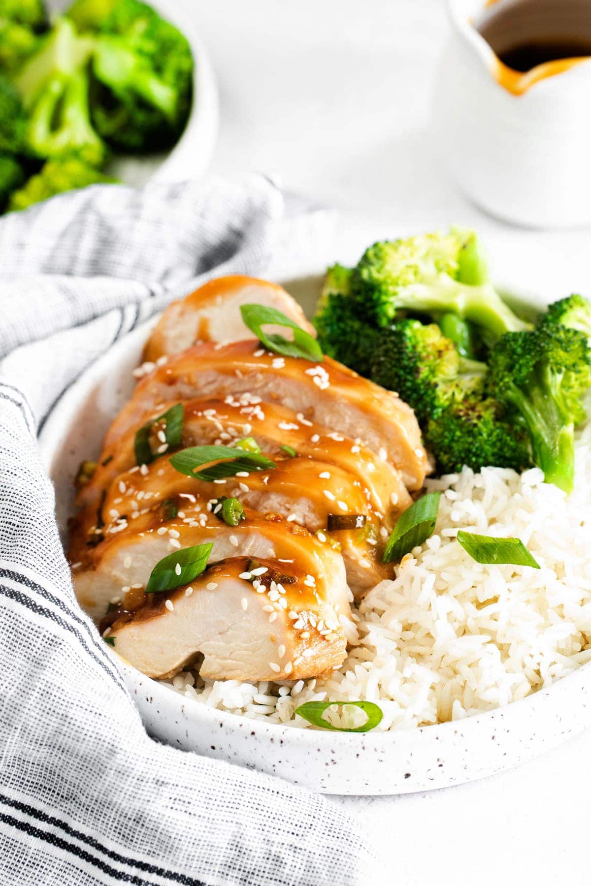 sliced teriyaki chicken with white rice and broccoli in bowl