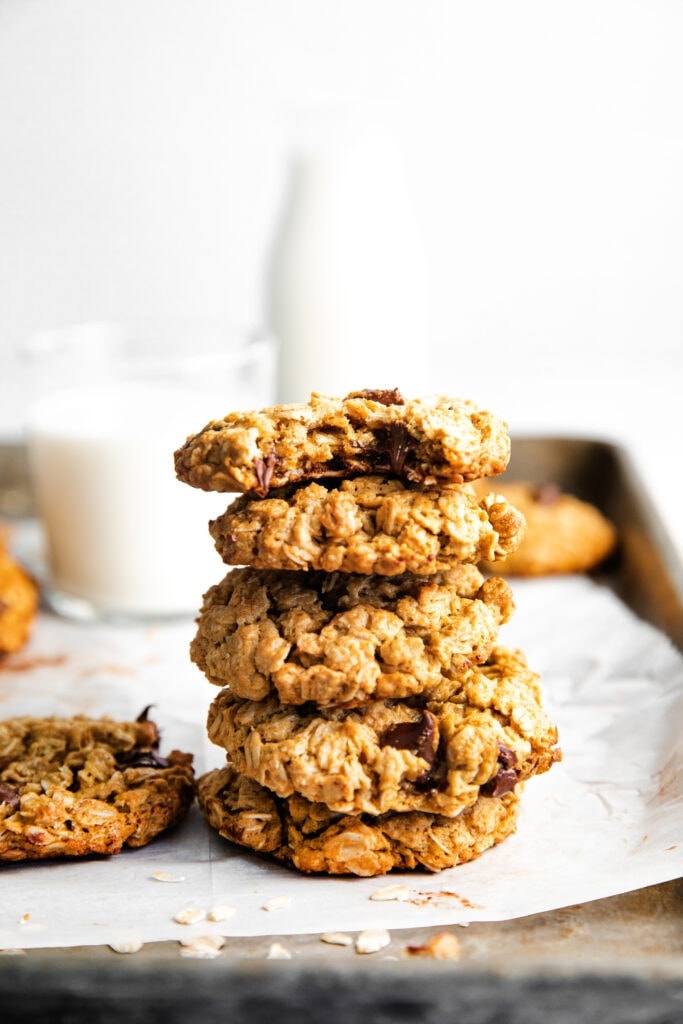 Perfectly chewy on the inside and crispy on the outside peanut butter chocolate chip cookies. These are seriously the best healthy peanut butter oatmeal cookies you've ever had! stack of oatmeal cookies