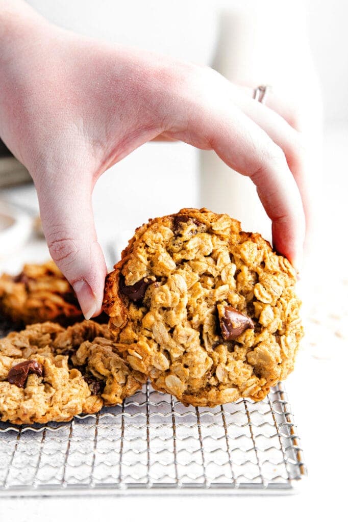 Perfectly chewy on the inside and crispy on the outside peanut butter chocolate chip cookies. These are seriously the best healthy peanut butter oatmeal cookies you've ever had! healthy peanut butter oatmeal cookies on wire rack