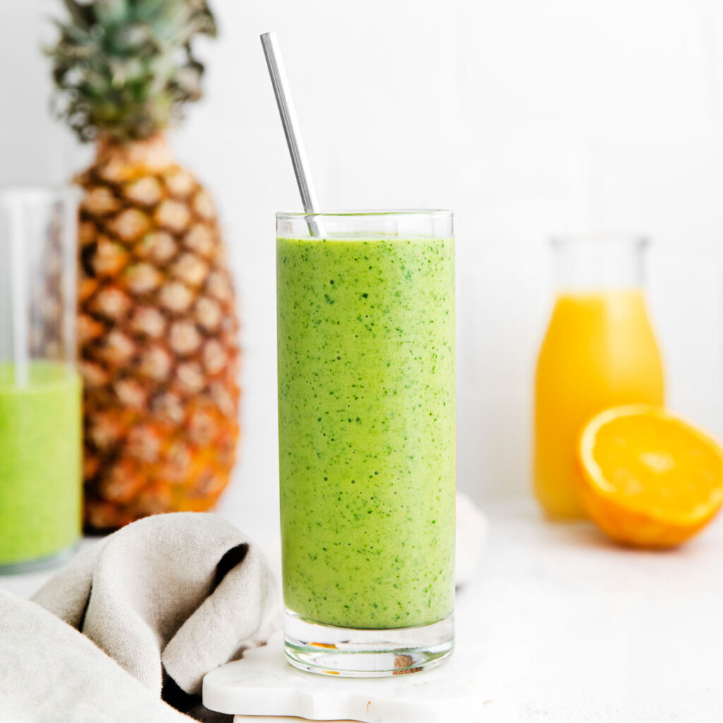 Spinach smoothie in a tall glass.