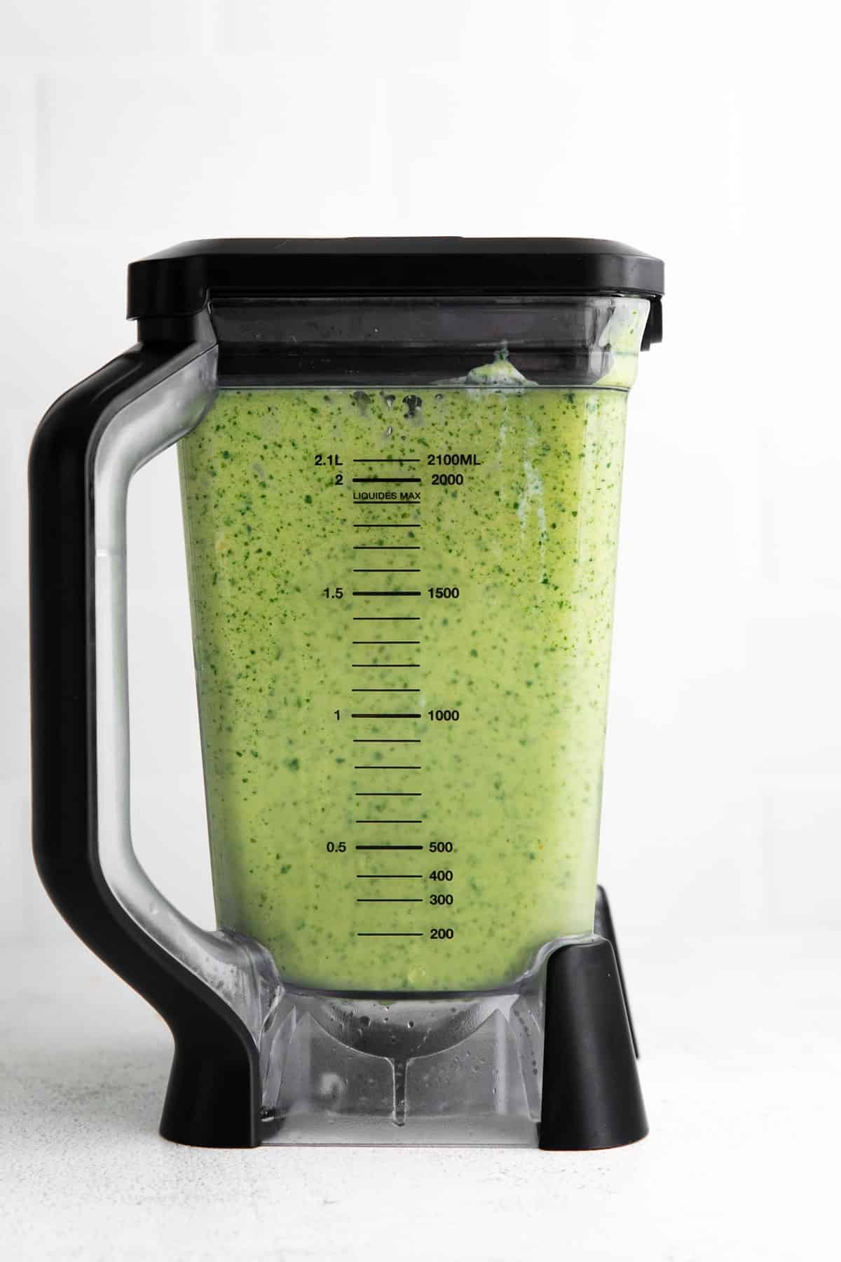 Tropical Spinach Smoothie blended up in a blender. 