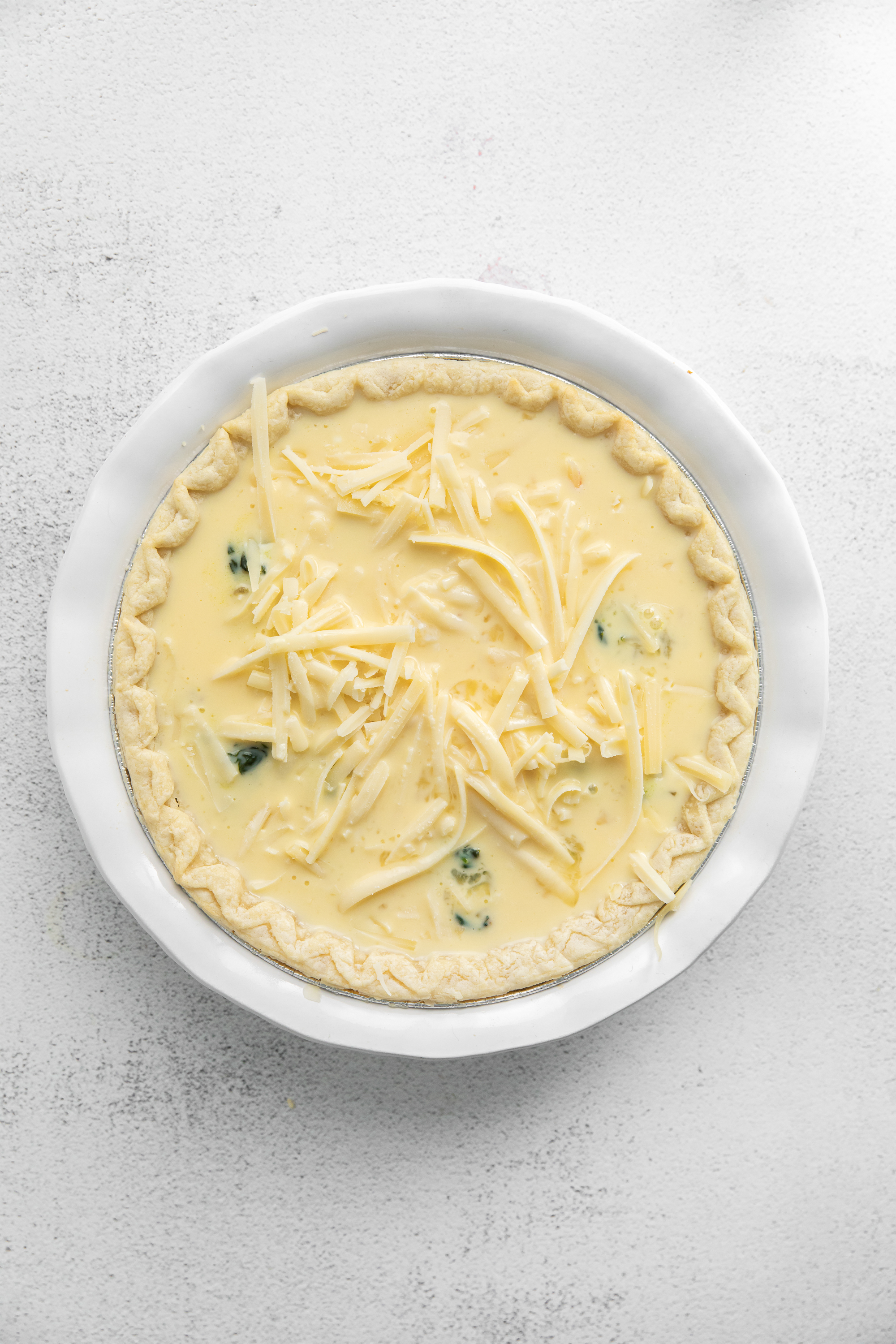 Cheese sprinkled on top of a quiche. 