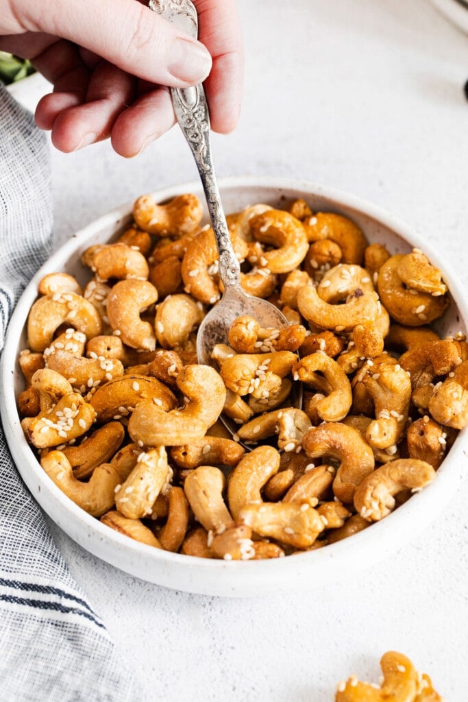 roasted cashews in bowl with spoon
