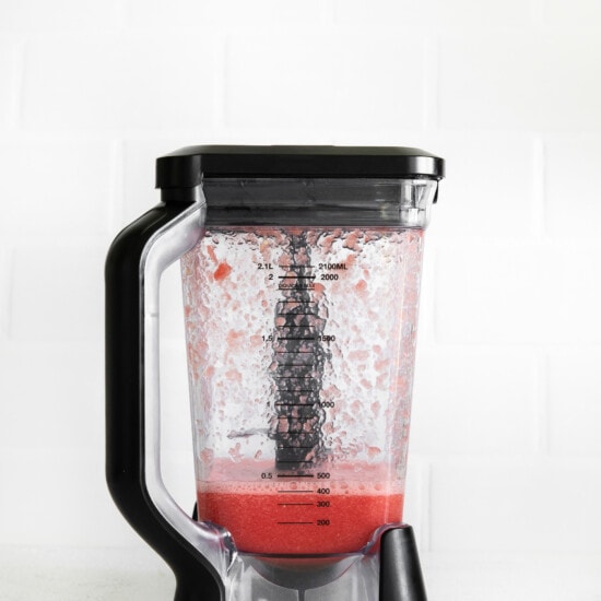 a blender filled with a strawberry smoothie.