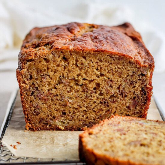 a slice of banana bread on a cooling rack.