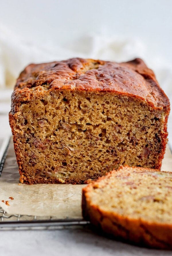 a slice of banana bread on a cooling rack.