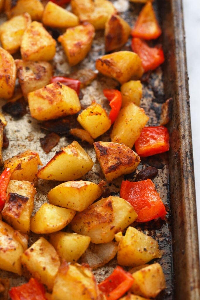 breakfast potatoes on a baking sheet looking crispy and delicious