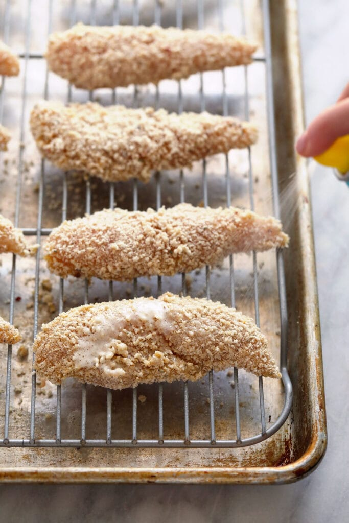 Chicken tenders on a baking rack.