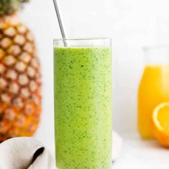 tropical pineapple smoothie in a glass with straw