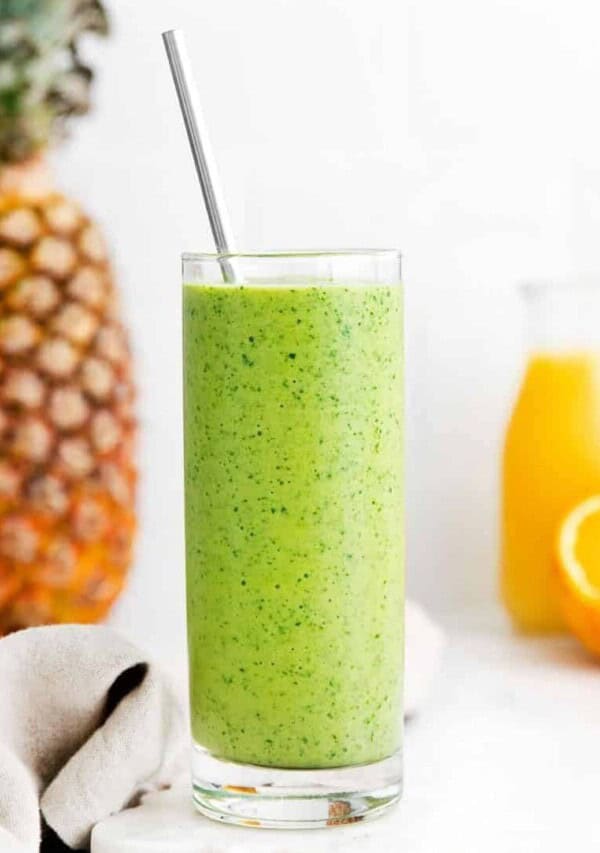 tropical pineapple smoothie in a glass with straw