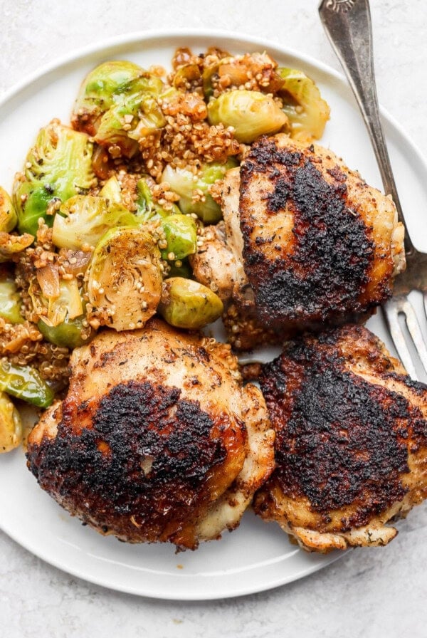 roasted chicken and brussels sprouts on a plate.