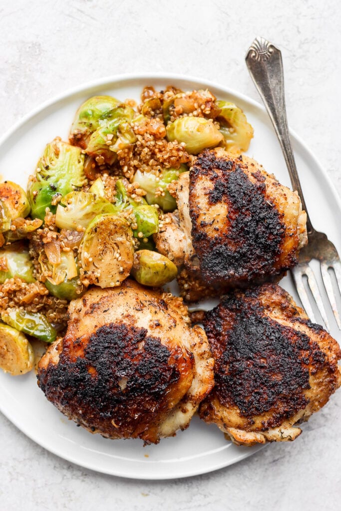 chicken thighs, Brussels sprouts, and quinoa on plate