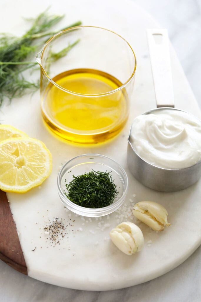 Greek yogurt salad dressing ingredients on cutting board