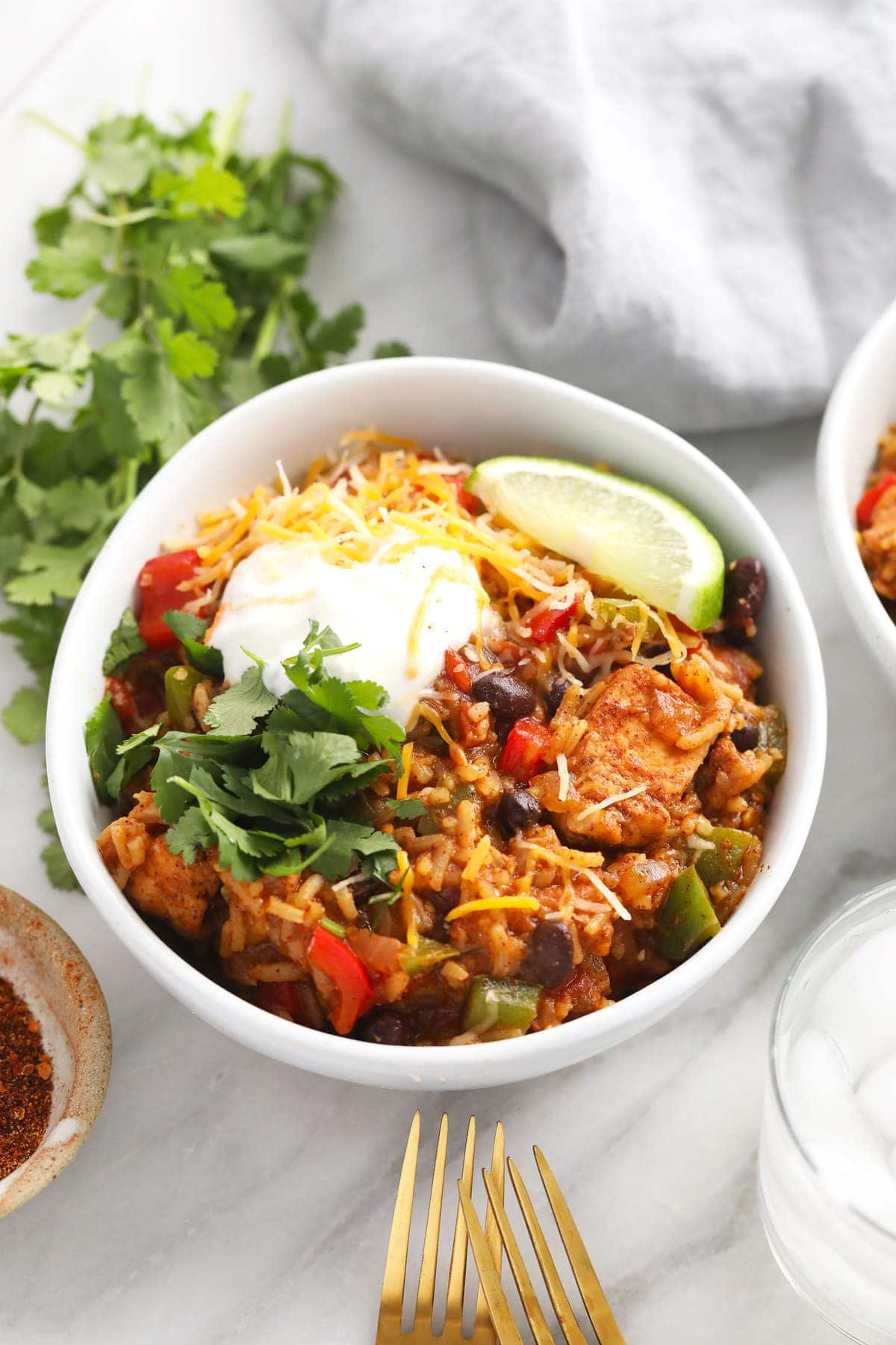 instant pot burrito bowl topped with greek yogurt and shredded cheese