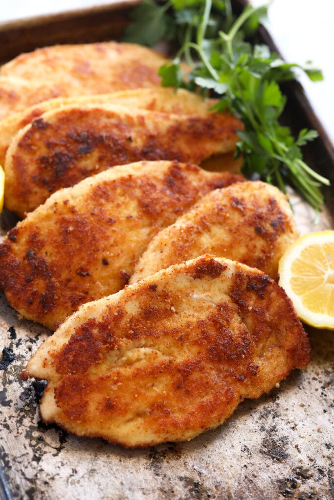6 parmesan crusted chicken breasts on baking sheet