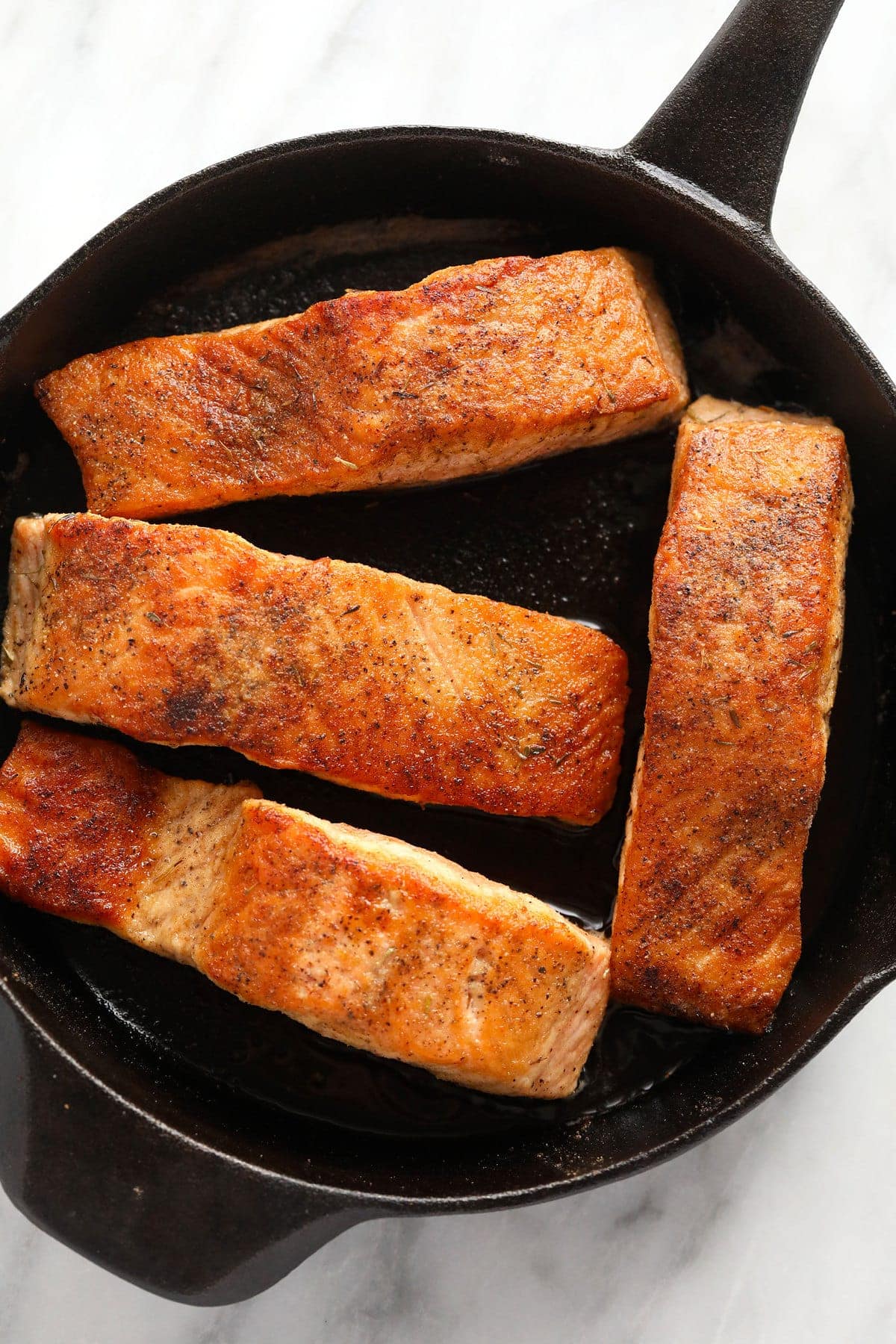 Salmon filets in a cast iron.