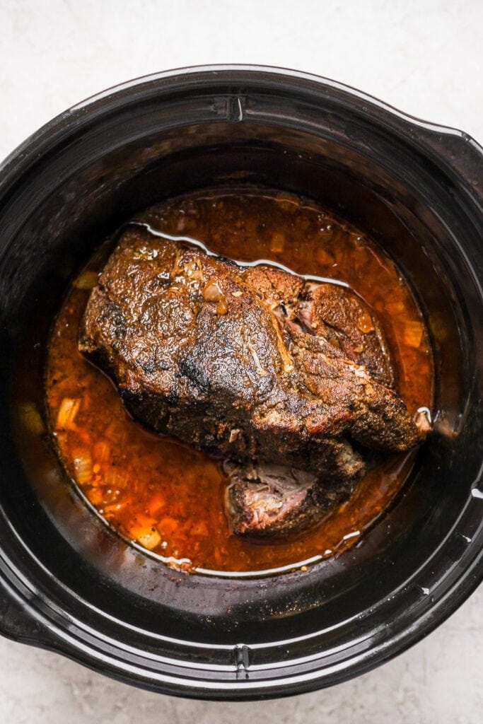 A pork roast in a slow cooker. 