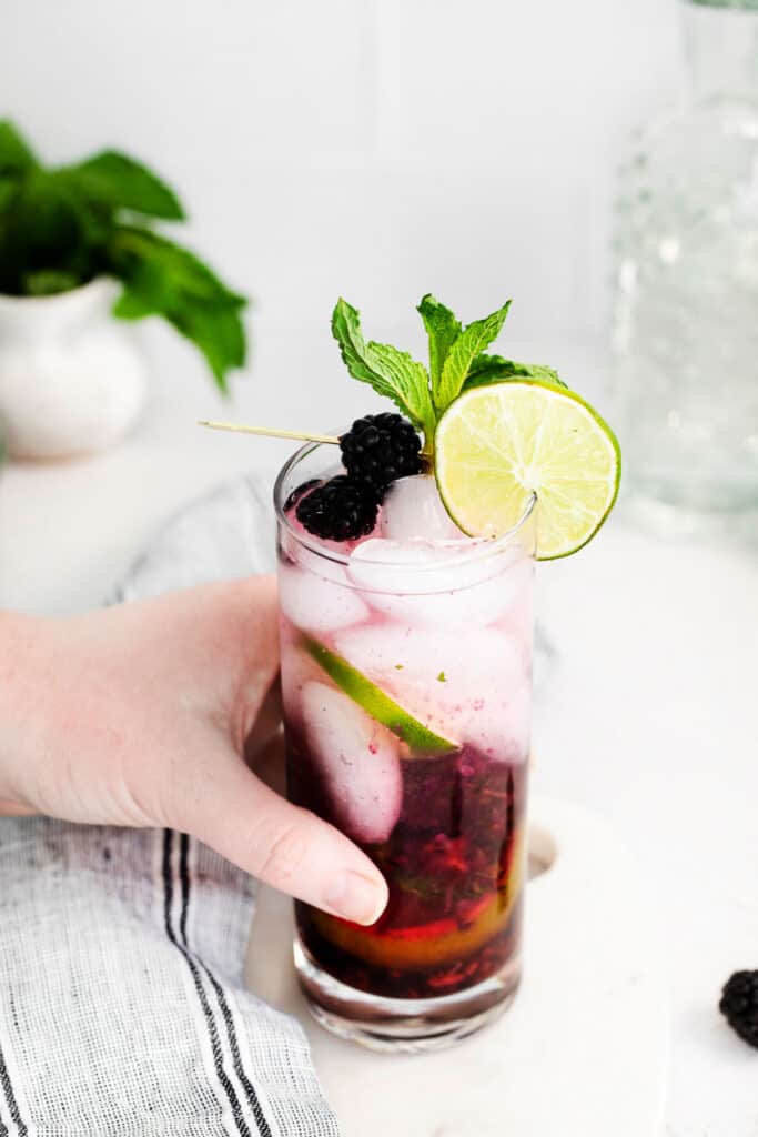 hand holding blackberry cocktail