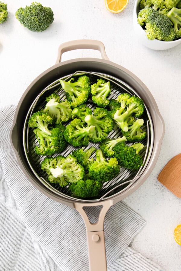 a pan with broccoli and lemons on it.