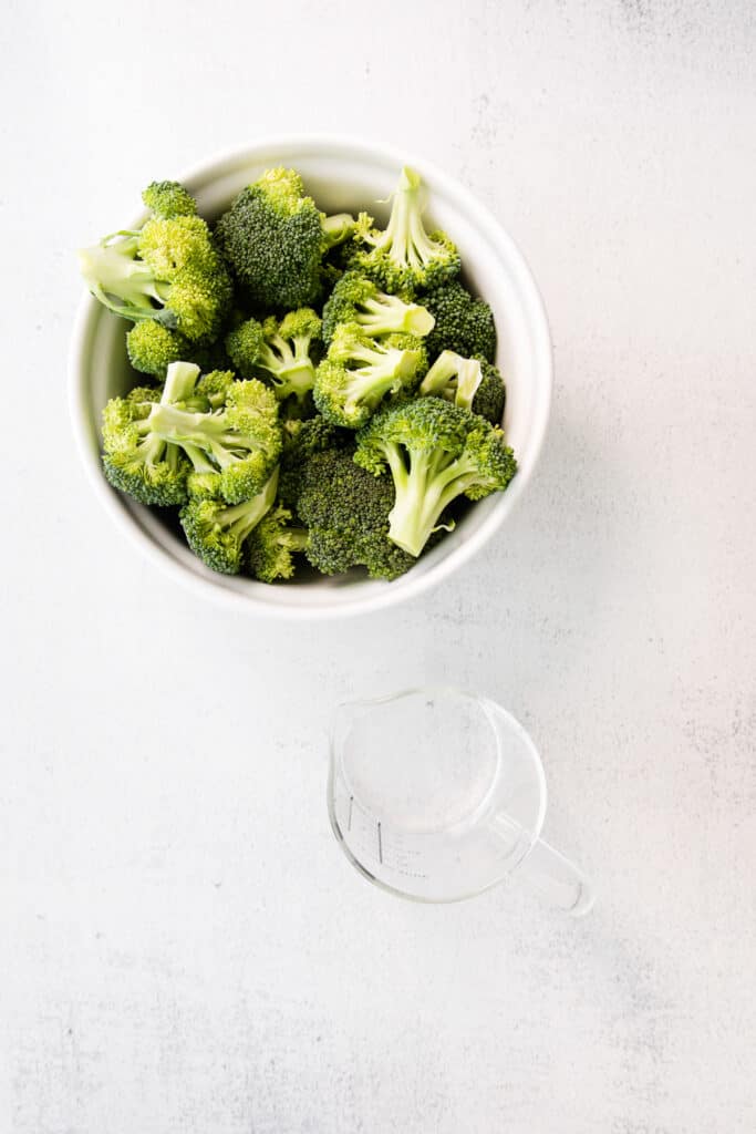 broccoli in bowl and water in cup