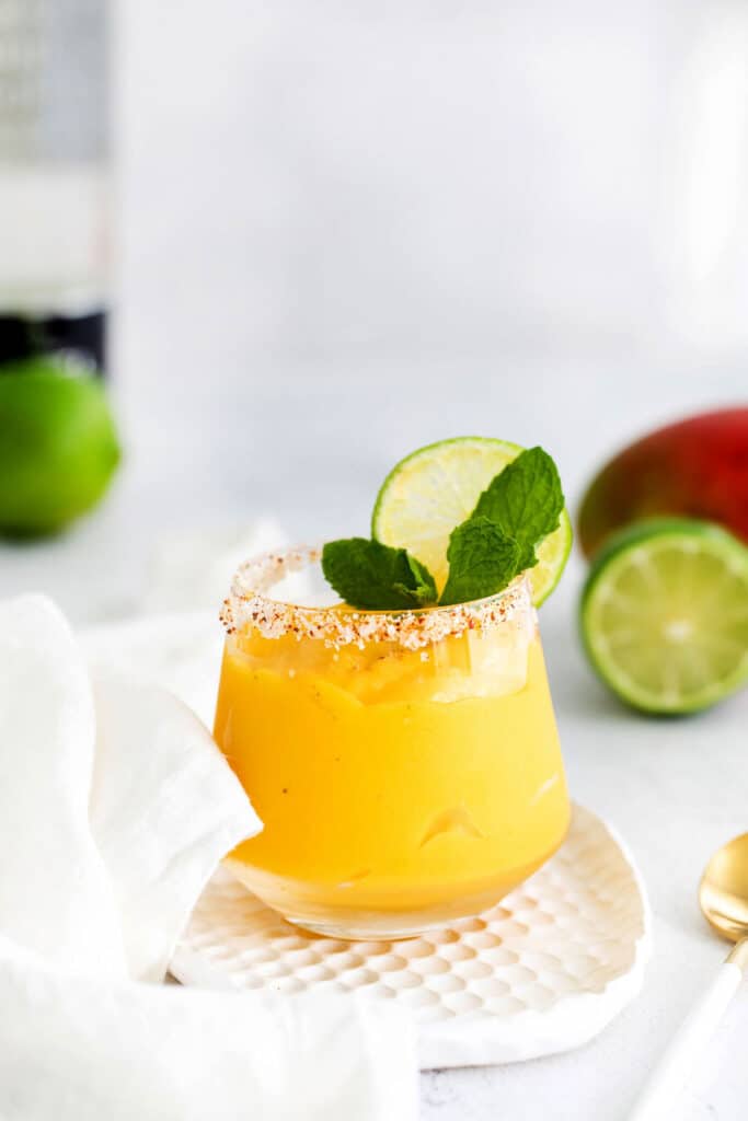 Mango margarita in a glass with mint.