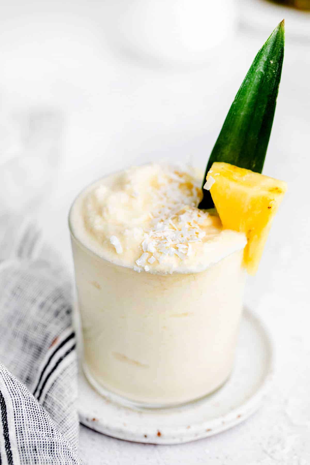 pina colada in glass with frozen pineapple