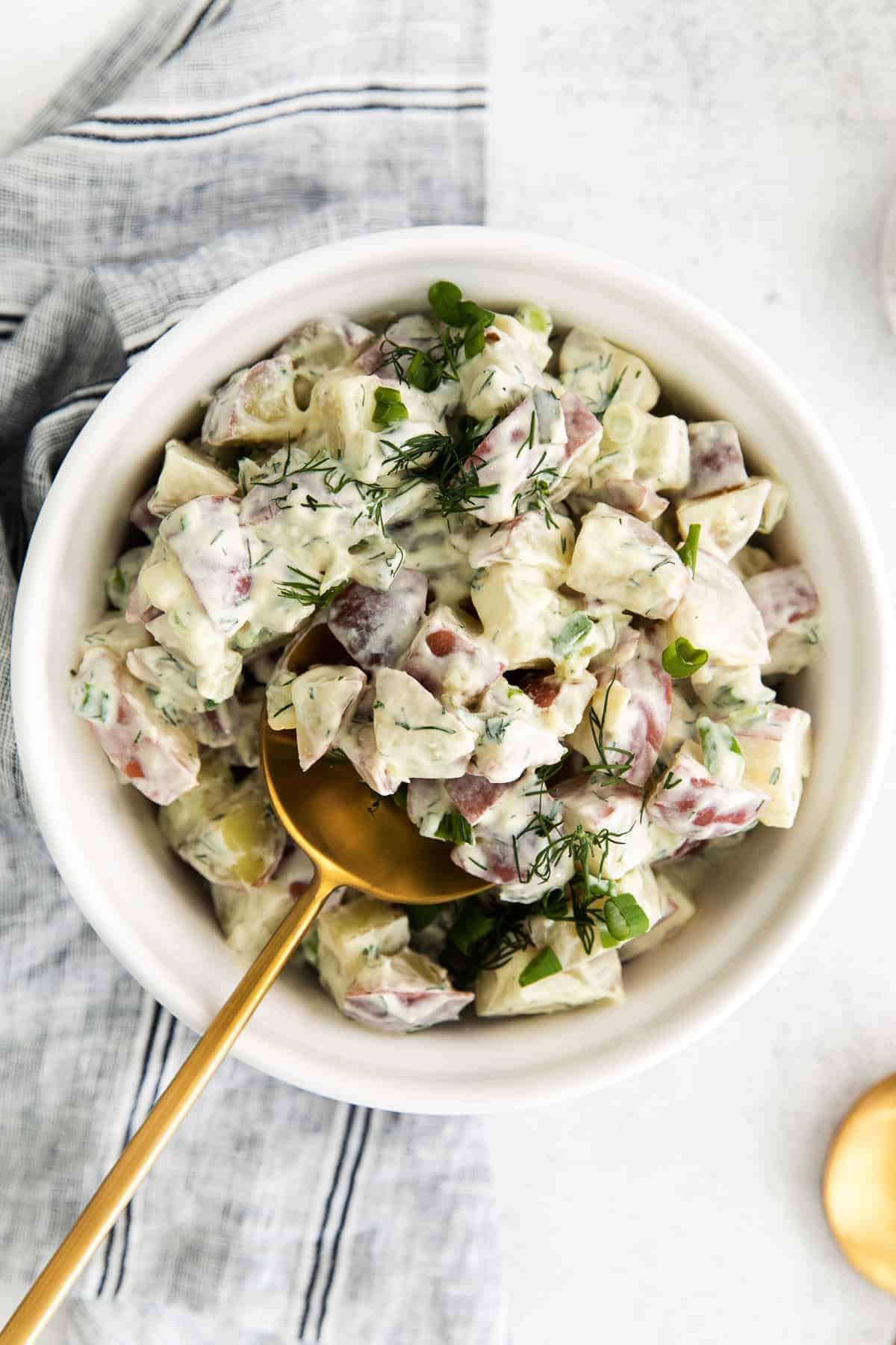 A bowl of red potato salad. 