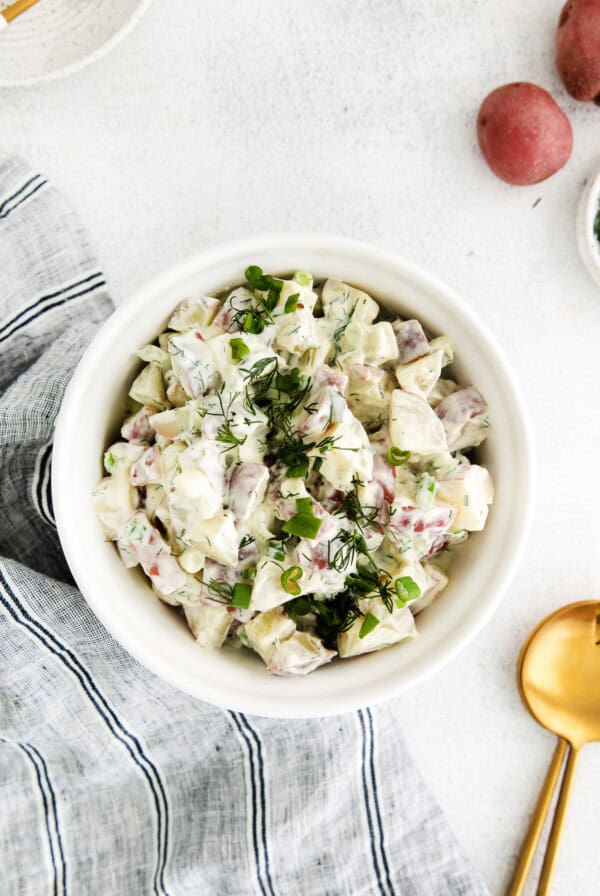 Red potato salad in a bowl.