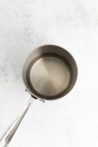 a stainless steel frying pan on a white background.