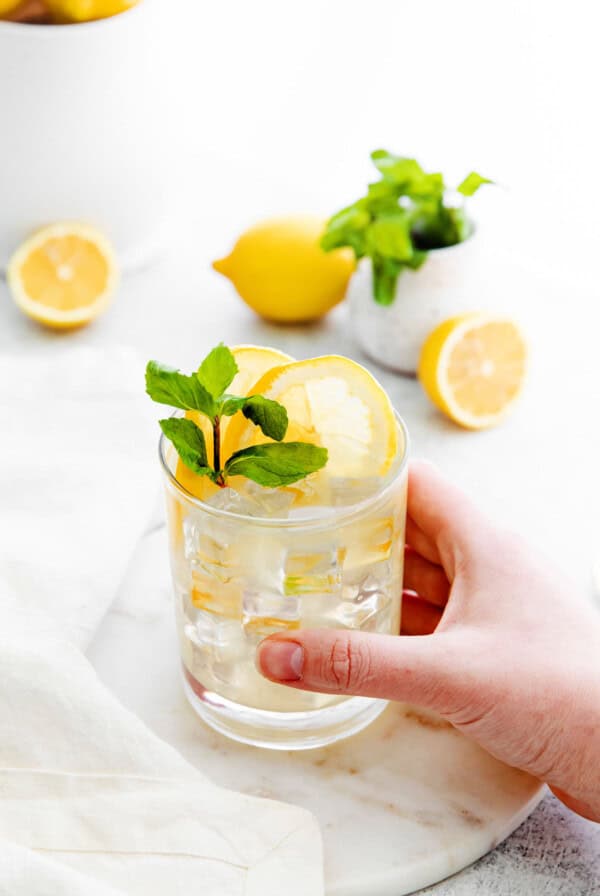 vodka lemonade in glass with hand