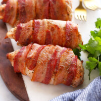 bacon wrapped chicken on cutting board