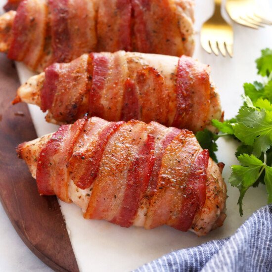 bacon wrapped chicken on cutting board
