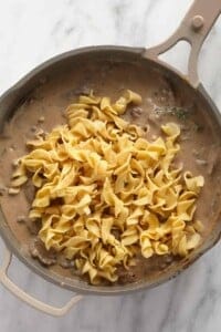 A skillet filled with beef stroganoff.